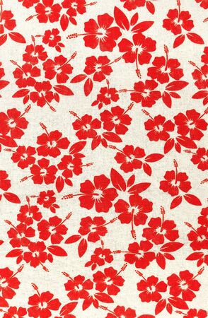 red floral pattern on a fabric backdropの写真素材