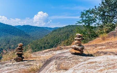 Pile of stones atop a hill and overlooks the beautiful skyの写真素材