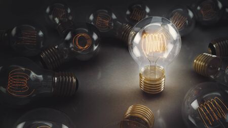 A single incandescent lightbulb surrounded by multiple bulbs on a reflective surface. One hero bulb...