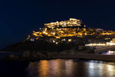 A panoramic view of Castelsardo, in Italy, by nightの写真素材