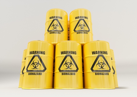 Yellow metal barrels with black biohazard warning sign isolated on white backgroundの写真素材