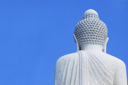 Big Buddha white marble. Back side view with clear blue sky background.の写真素材