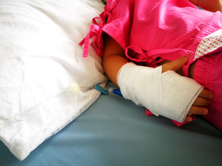 Children are sick and use saline solution at the hospital, Climate change causes the flu.の写真素材