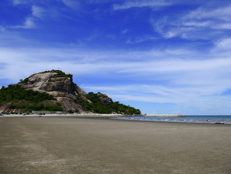 Sandy beaches with rocky mountains and blue sky background.の写真素材