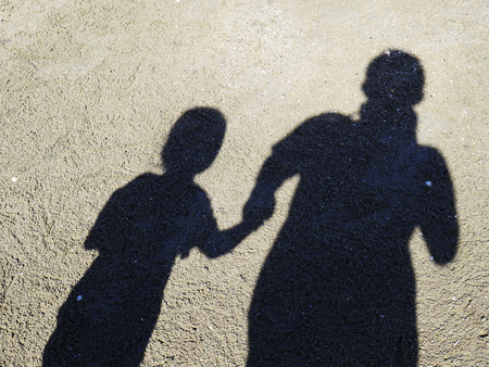 Shadow of father and daughter on the beach on the beach, Shadow of people.の写真素材