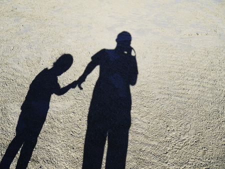 Shadow of father and daughter on the beach on the beach, Shadow of people.の写真素材