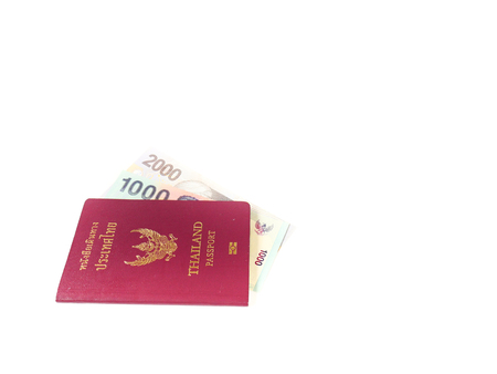 A passport of Thailand and a banknote isolate on white background with copy space, Traveling concept.の写真素材