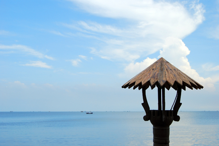 The wooden lanterns of the restaurant have a sea background and blue sky.の写真素材