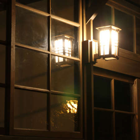 The Wooden old house with Reflection of Lighting