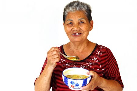 Happy old Woman who Eat beef curry Gruelの写真素材