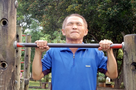 A man who Struggling upwards by Horizontal bar