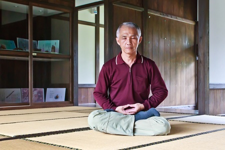 A Chinese man sit quietly for practicing Zen meditationの写真素材