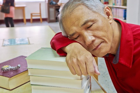 A Doze reader who is reading in the libraryの写真素材