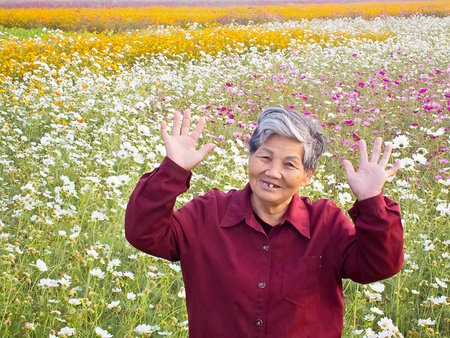 A White hair SMILING Chinese old woman Show of hands in Gardenの写真素材