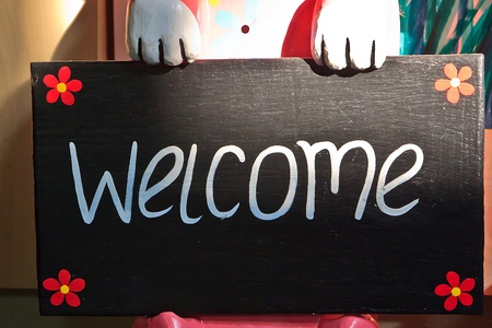 A creative signboard with Character of Welcome