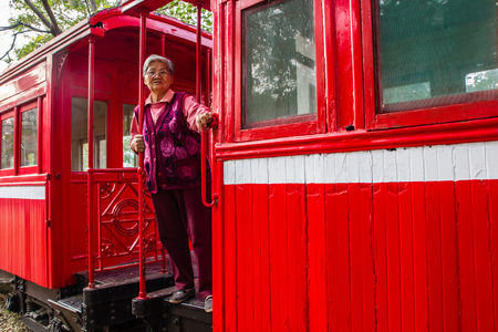 Old woman on a Sightseeing Train for Tourismの写真素材