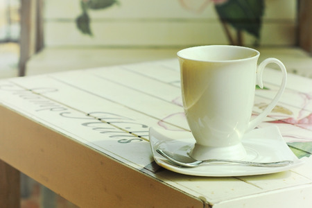 hot coffee on paint wooden table with vintage style の写真素材
