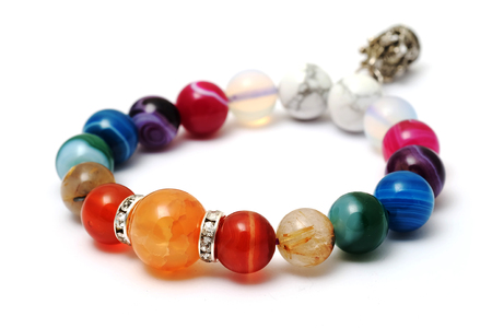 Colorful of agate,jasper bracelet decorate with silver crown pendant with white isolated backgroundの写真素材