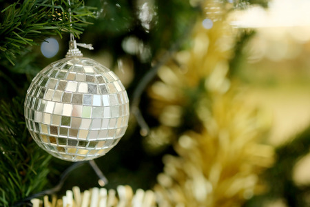 Mirror ball decorate hanging on green pine tree for happy Christmas festivalの写真素材