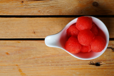 scoop red watermelon in white cup on wooden table and have some space for write wordindの写真素材