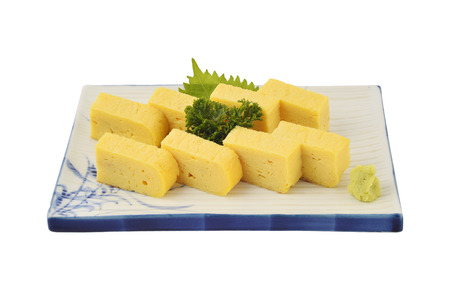 Tamago set in white square dish. Sweet Omelet or egg roll in Japaneses tradition style with isolated backgroundの写真素材