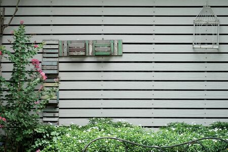 decorative wall with shelf make from white wood in garden texture backgroundの写真素材