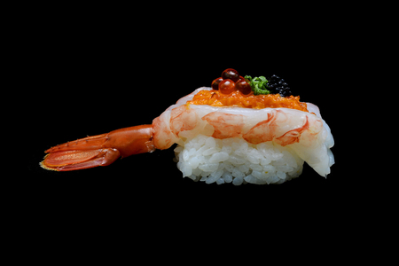 Botan ebi sushi or Spacial premium king shrimp sushi mixed by ikura and caviar top on Japanese rice. Japanese tradition food with black isolated backgroundの写真素材