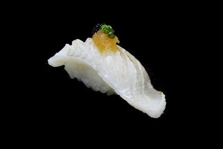 Aburi Engawa Sushi, torched flatfish on rice topping with Spring onion and minced daikon and caviar. Japanese tradition cuisine with black isolated backgroundの写真素材