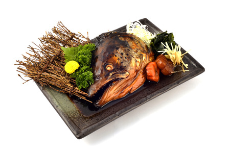 Salmon Head with special Soy Source. Japanese tradition cuisine with white isolatedの写真素材