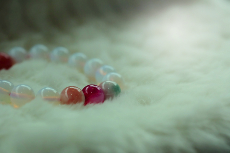 pink agate and Moonstone lucky fortune  bracelet on white wool background. Amulet accessories for good good lucky fortune and happy lifeの写真素材