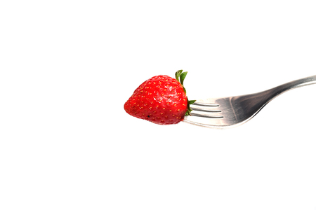 healthy Strawberry impale with stanley fork on white isolated backgroundの写真素材