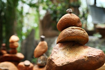 Create balance with meditation rock tower for make meditation peaceful with forest background with...