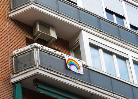 Poster with rainbow against Coronavirus at a window or balcony in Spainのeditorial素材