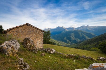 View of houses with tile roofs against mountains in the eveningの写真素材