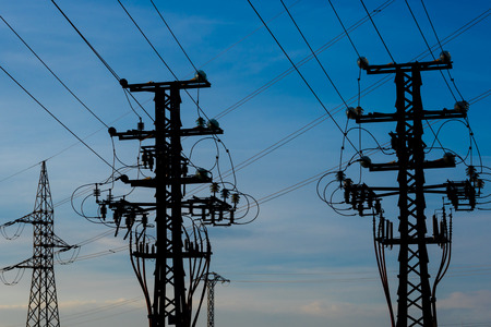 The equipment of a high voltage electric against the evening skyの写真素材