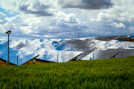 Silicon panels of solar batteries against the cloudy sky in the middle of the day.の写真素材