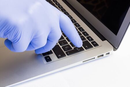 We work on a computer using personal security tools. Mask, gloves.