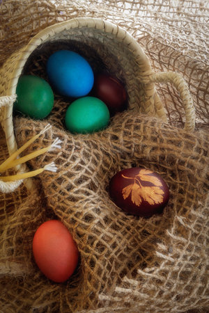 The holiday of Easter, hen eggs painted in the traditional colors, kulich, festive cake, church candles.の写真素材