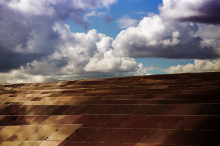 Silicon panels of solar batteries against the cloudy sky in the middle of the day.の写真素材