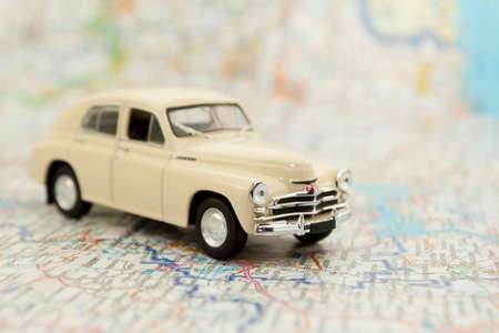 Vintage toy car on mapの写真素材