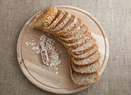 slices of fresh bread with cereals on a wooden stand