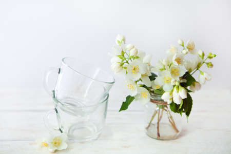 Still life details, cup of tea on retro vintage wooden table and  beautiful summer bouquet of jasmine.Lazy summer weekendsの写真素材