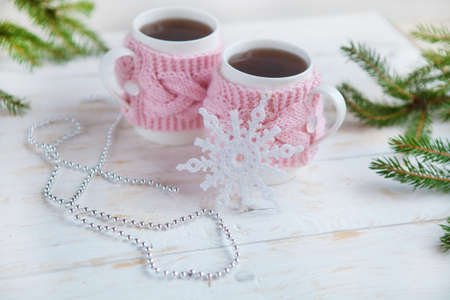 cup of tea with christmas decorations on white wooden table