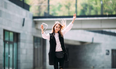 Photo of young beautiful smiling woman close-up portrait of a young sexy girl hipster The concept of street fashion. Young beautiful model in the city.の写真素材