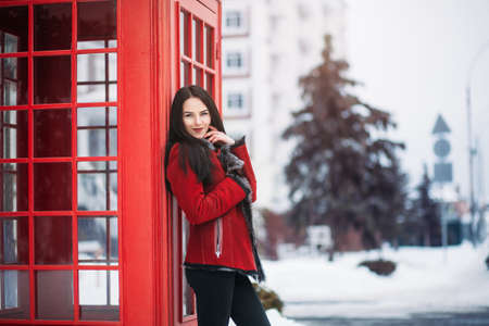 Sunny frozen morning of fashionable young woman smiling on winter street full of snow. Amazing girl...