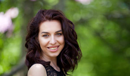 Beauty smiling model with natural make up and long eyelashes. Youth and skin care concept. Spa and wellness. Make up, long hair and lashes. Close up, selective focus.の写真素材