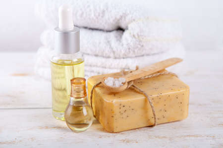 Aromatic spa set with sea salt natural handmade soap and oil on a white wooden background. Composition of spa treatmentの写真素材