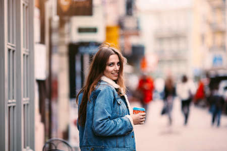 Outdoor fashion portrait of stylish young woman having fun, emotional face , laughing, looking at camera. Urban city street style.Copy space for textの写真素材