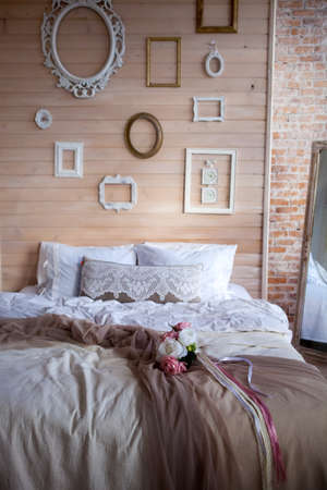Shabby chic interior decor The bedroom is in the style of Provence wooden wall decorated with photo...