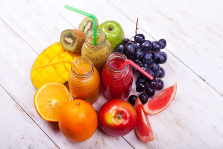Row Fresh Juices Smoothie Three Bottles Red Green Orange Fruits Vitamins Healthy Concept on white.の写真素材